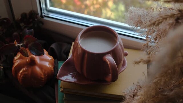 Fall vibes. Woman relaxing drinking cocoa near window. Warm cozy autumn mood. 