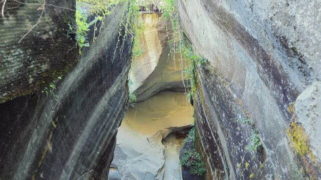 A view from the bottom looking up, showing the beauty of the structure and colors of an old stone quarry used to make millstones and grinding stones