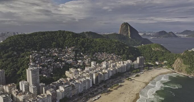 Rio de Janeiro Brazil Aerial v20 rising flyover famous Copacabana Beach, capturing sandy beach, vibrant cityscape with Sugarloaf Mountain in the background - Shot with 5k Camera - Mar 25th 2024