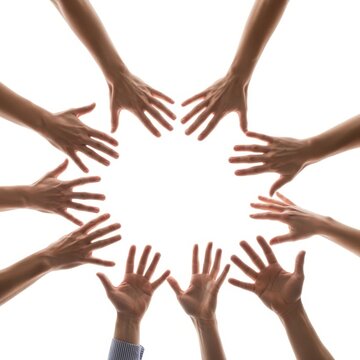 Group of hands raised together in unity