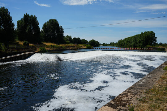 Stepped weir with foaming white water on a river
