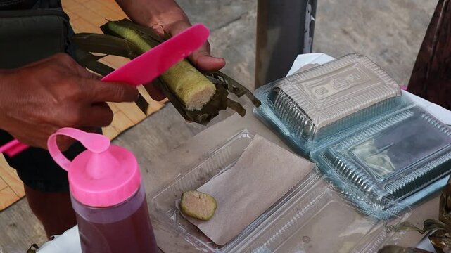 Lupis or lopis is a traditional Indonesian sweet cake made from sticky rice wrapped in banana leaves served with coconut and brown sugar sauce.