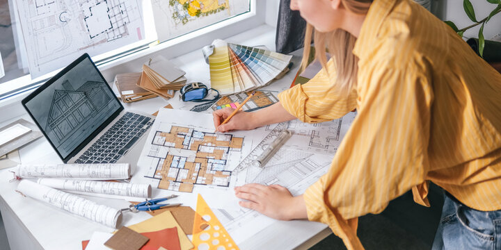architect Eco retrofit planning with blueprints, material swatches and finish samples, sustainable renovation budget and healthy material selection concept for honest architectural design.