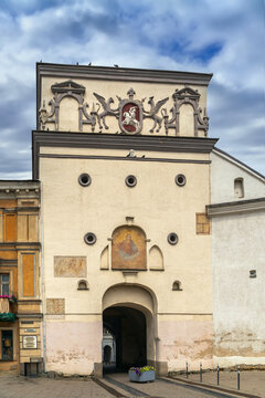 Gate of Dawn in Vilnius, Lithuania, view from the southern side. Part cloudy sky over historic city gate architecture