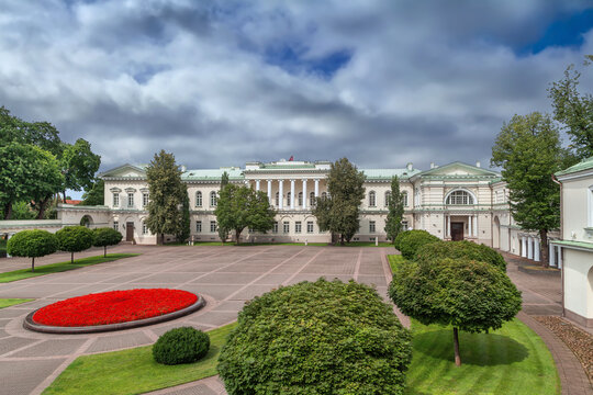 Presidential Palace in Vilnius, Lithuania, view from the courtyard garden. Classicist palace architecture under daytime sky.