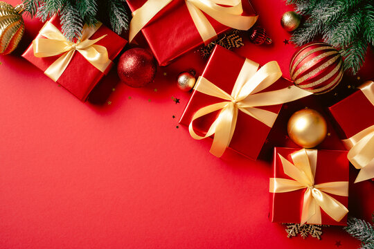 Red Christmas gift boxes with gold ribbons and ornaments
