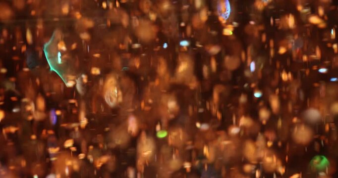 Small orange confetti fragments descend in different directions. Colorful paper pieces with various shapes sizes and delicate textures swirl