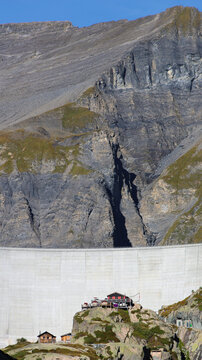 View of the Lac du Vieux Emosson dam set against the rugged rocky mountains of the Swiss Alps in Finhaut, Valais, Switzerland.