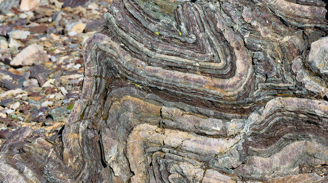 View of intricate geological rock folds with layered sedimentary strata and natural textures near Lac du Vieux Emosson in Finhaut, Valais, Switzerland.