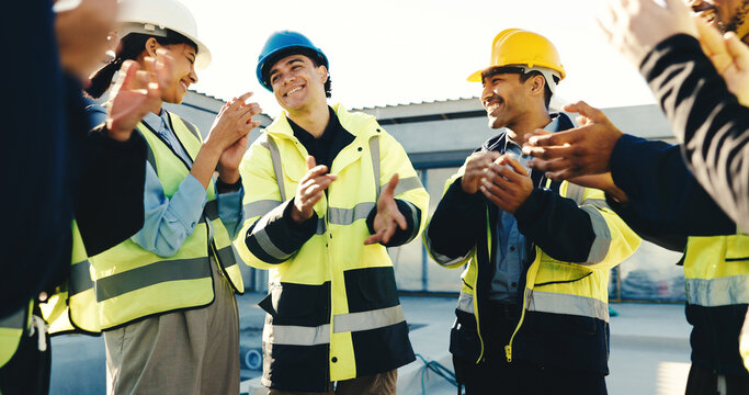 Happy, technician and team at construction site with applause, property development success or goals. People, electrician or engineer clapping outdoor with celebration, building approval or good news