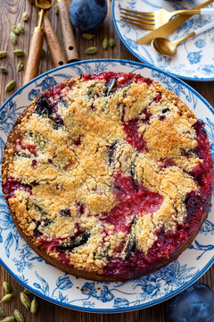 Delicious homemade plum crumble pie on blue floral plate