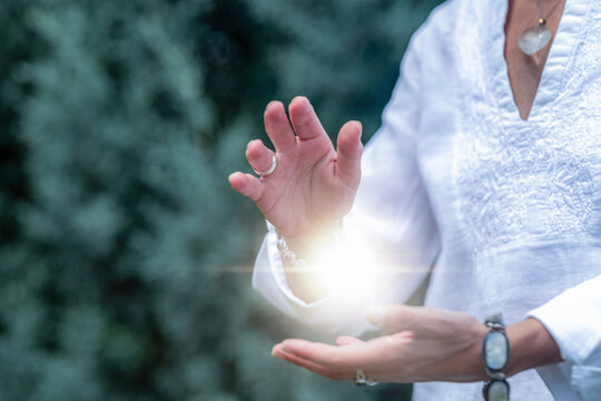 Mindfulness practice channeling healing light between the hands, spiritual energy meditation