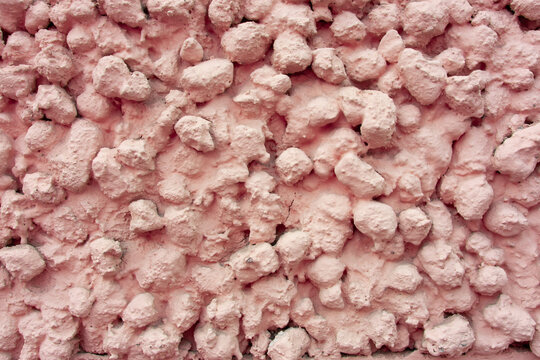 Pink pebbledash plaster wall texture