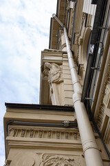 Classical building facade with atlas sculpture, low angle view © Mariia