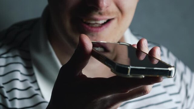 A voice message on the phone.
A man is recording a voice message or talking on the phone.