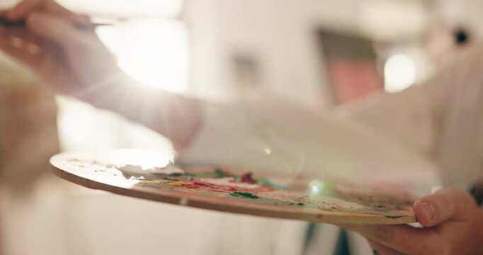 Artist, hands and person painting with palette for sketch inspiration, talent or creative process. Painter, art and brush stroke for artistic design, artwork color or drawing with flare in studio