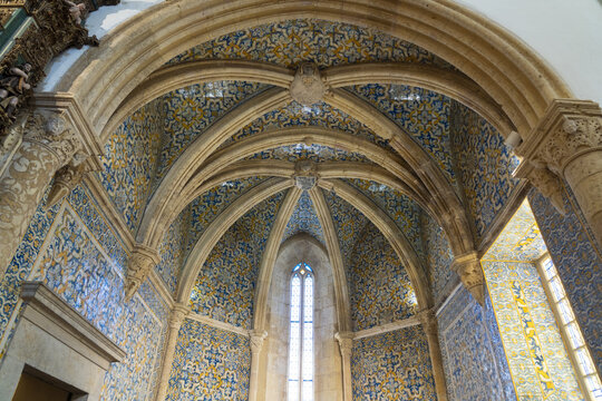 View of the ornate vaulted ceiling and intricate blue and yellow azulejo tile work inside the historic Cathedral of Faro, Faro, Faro District, Portugal.