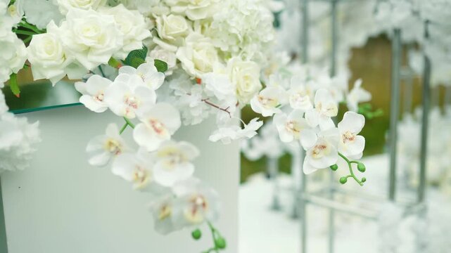 wedding arch of white rose flowers in the forest before the wedding ceremony of the bride and groom, festive romantic boho style decor