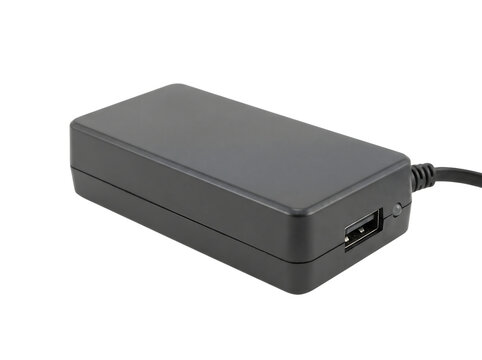 Black electronic power adapter and laptop charger unit isolated on white background with cable connector