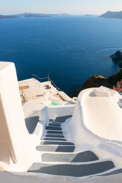 White architecture in Santorini island, Greece. Stairs to the sea. Blue sea and the blue sky at sunset.