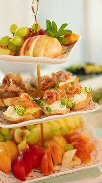 Catering service on banquet table with canape snacks in restaurant or hotel. Decorated food set on birthday, wedding celebration or business conference event venue.