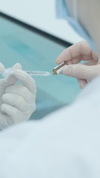 Professional ophthalmologist performing cataract removal and intraocular lens (IOL) implantation under a surgical microscope in an operating room.