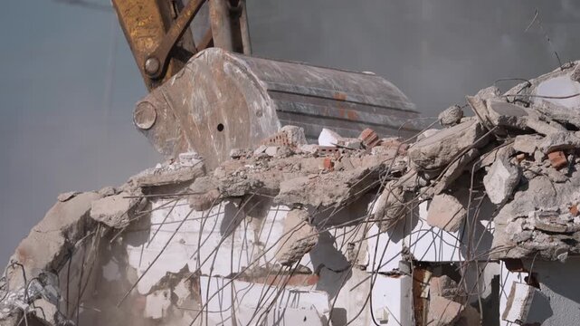 A crane demolishing a multi-story building in sunny weather.