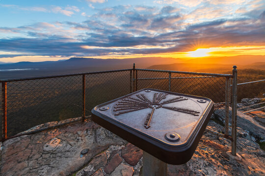 Panoramic view across Victoria Valley from Reed Lookout in Grampians National Park, Victoria, Australia. A topographical orientation table provides information about the surrounding mountains