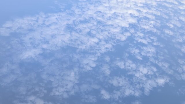 Cirrus clouds drift slowly against a clear blue sky in an uninterrupted sequence of natural beauty
