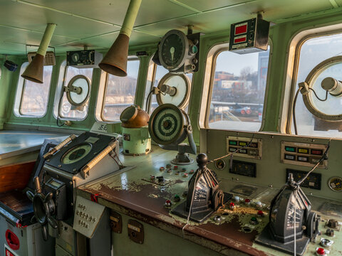 View of the interior of a ship's bridge at the War Memorial of Korea, featuring navigation equipment, control panels, and steering wheel in Seoul, South Korea.