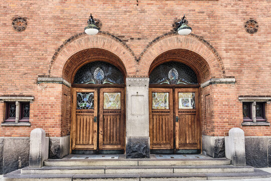 Viborg, Denmark - 07 August 2026: View of the historic old Viborg theater entrance with ornate wooden double doors, stained glass panels, and red brick neoclassical facade.