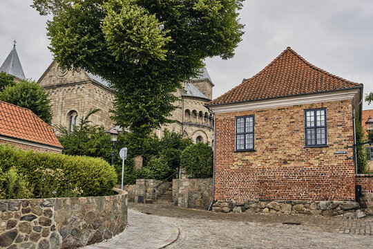 Viborg, Denmark - 07 August 2026: View of the historic courtyard of Viborg Stift with its traditional red brick masonry, cobblestone paths, and the nearby cathedral.