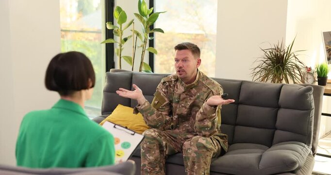 Compassionate psychologist speaks with military man during therapeutic session. Male describes disturbing and emotionally overwhelming event at war