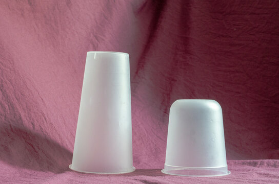 Stacked plastic cups on a simple fabric background