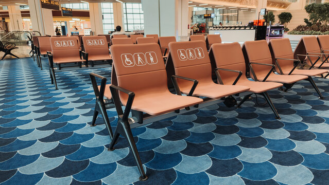 Bhogapuram, India - 22 August 2026: View of Alluri Sitarama Raju International Airport terminal seating with accessibility icons and blue patterned carpet.