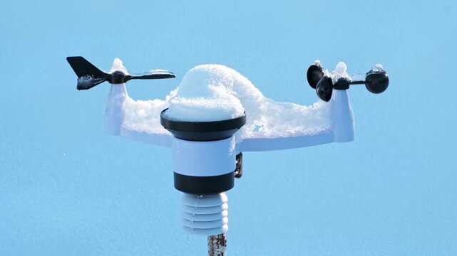 Wireless weather station on pole in snow. Sensors of temperature and humidity, Rain gauge and snow, Wind speed and direction. Climate monitoring, atmospheric research, Meteorological equipment. 4K.
