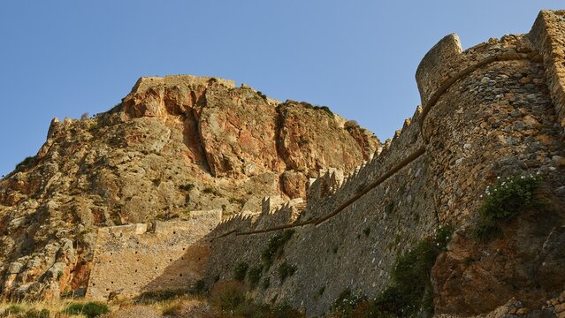 Mighty old city wall wraps around a dramatic rocky landscape, Monemvasia, Monemvassia, Malvasy, small Byzantine town, rocky island, fortress, Laconia, Peloponnese, peninsula, Greece
