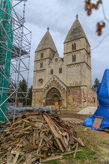Ják Abbey Church west facade with carved Romanesque portal during restoration, scaffolding beside, Vas County, Hungary © Michal Plevko