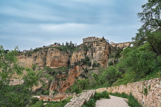 Famous Andalucia's Ronda town perched above El Tajo gorge, Spain, captured on an overcast day