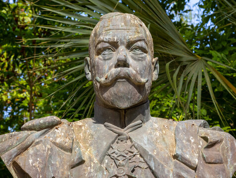 Frontal close up view of historic bronze bust sculpture of King George V in San Anton Gardens in Malta