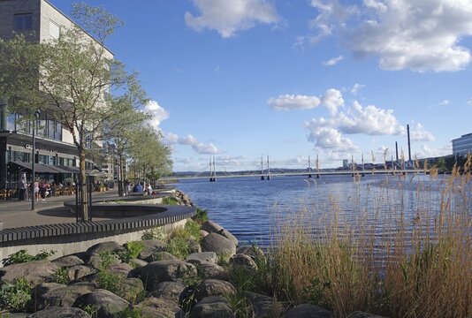 Lakeside with trees and boats, people walking along the water, urban architecture, J&ouml;nk&ouml;pings l&auml;n, J&ouml;nk&ouml;ping, Sweden