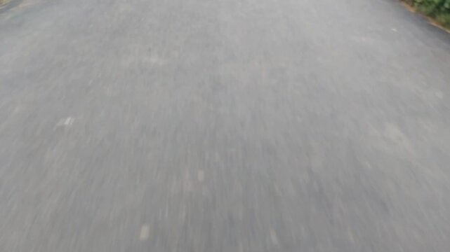 First Person View of Driving Fast on Empty Asphalt Road with Motion Blur
