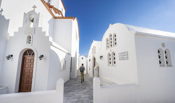 Chapel of Agios Antonios and Greek Orthodox Church of Metamorfosi Sotiros, Young man in the alleys of the village of Marpissa, Paros, Cyclades, Greece