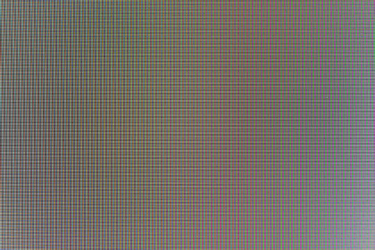 RGB led screen matrix close up with colorful red green blue subpixel blocks. Technical display grid