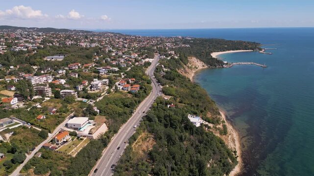Aerial view of coastal road along sea shoreline and beach bay in Varna