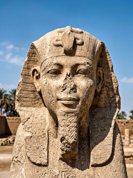 Ancient Egyptian Statue of Pharaoh With Uraeus on Sunlit Stone