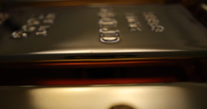 Shiny gold bullion with weight and fineness data stamped on top. Precious metal assets provide financial security and stability. Prosperity concept