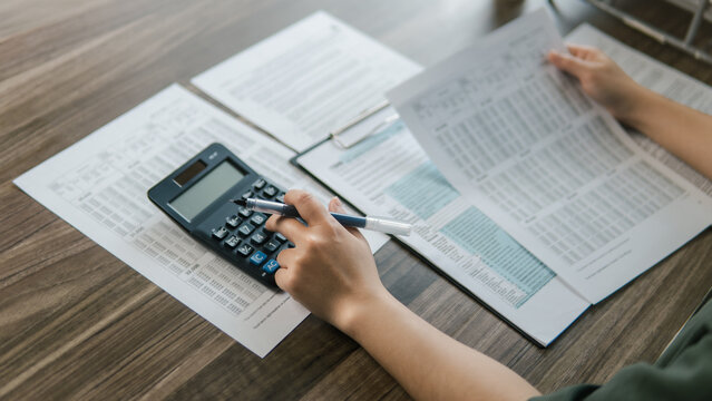 The concept of tax return preparation and financial management. Businessman calculates taxes. finance, Income tax, tax documents, and savings.