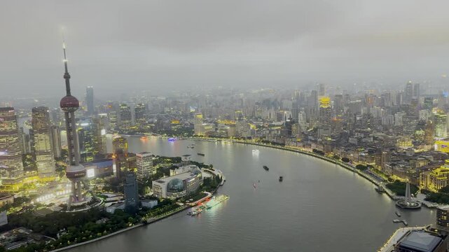 Rainy Shanghai skyline and Huangpu River at dusk