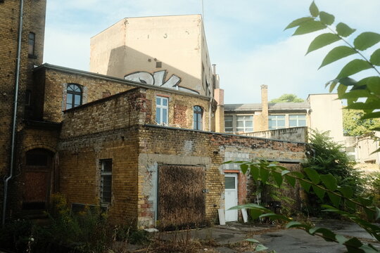 Leipzig, Germany - 15 September 2026: View of an old brick building with weathered walls and graffiti in an urban setting.